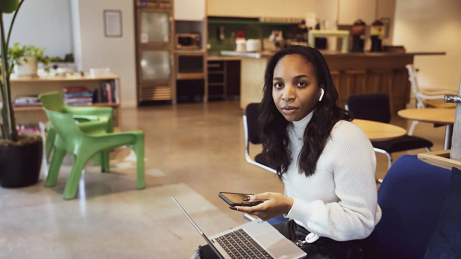 A new employee with a laptop and phone in a bright, open office