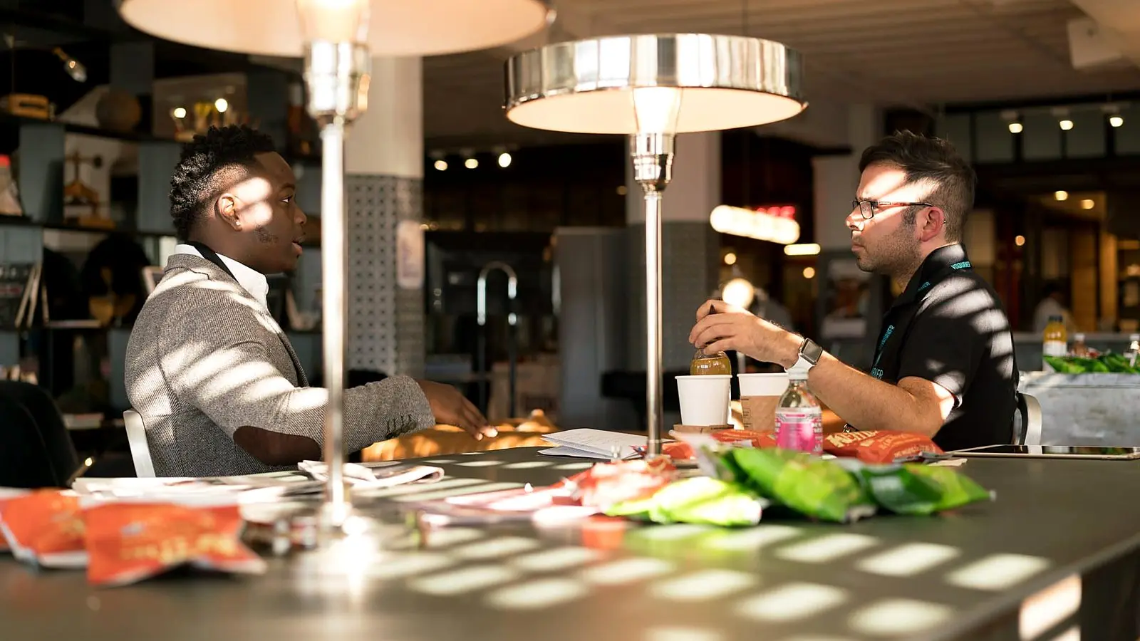 Two colleagues talking things through across a table