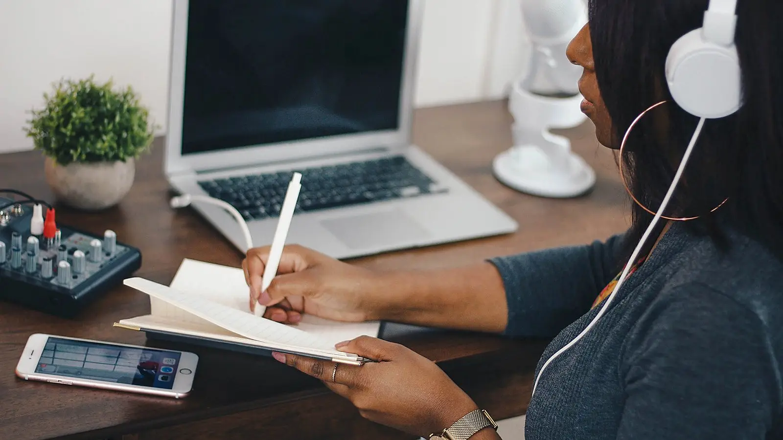 Planning dates in a notebook beside a laptop