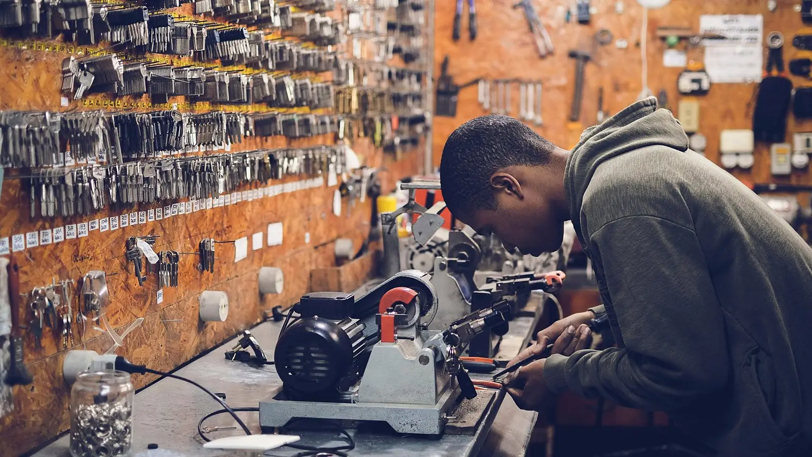 A craftsman at work at a workshop bench full of tools