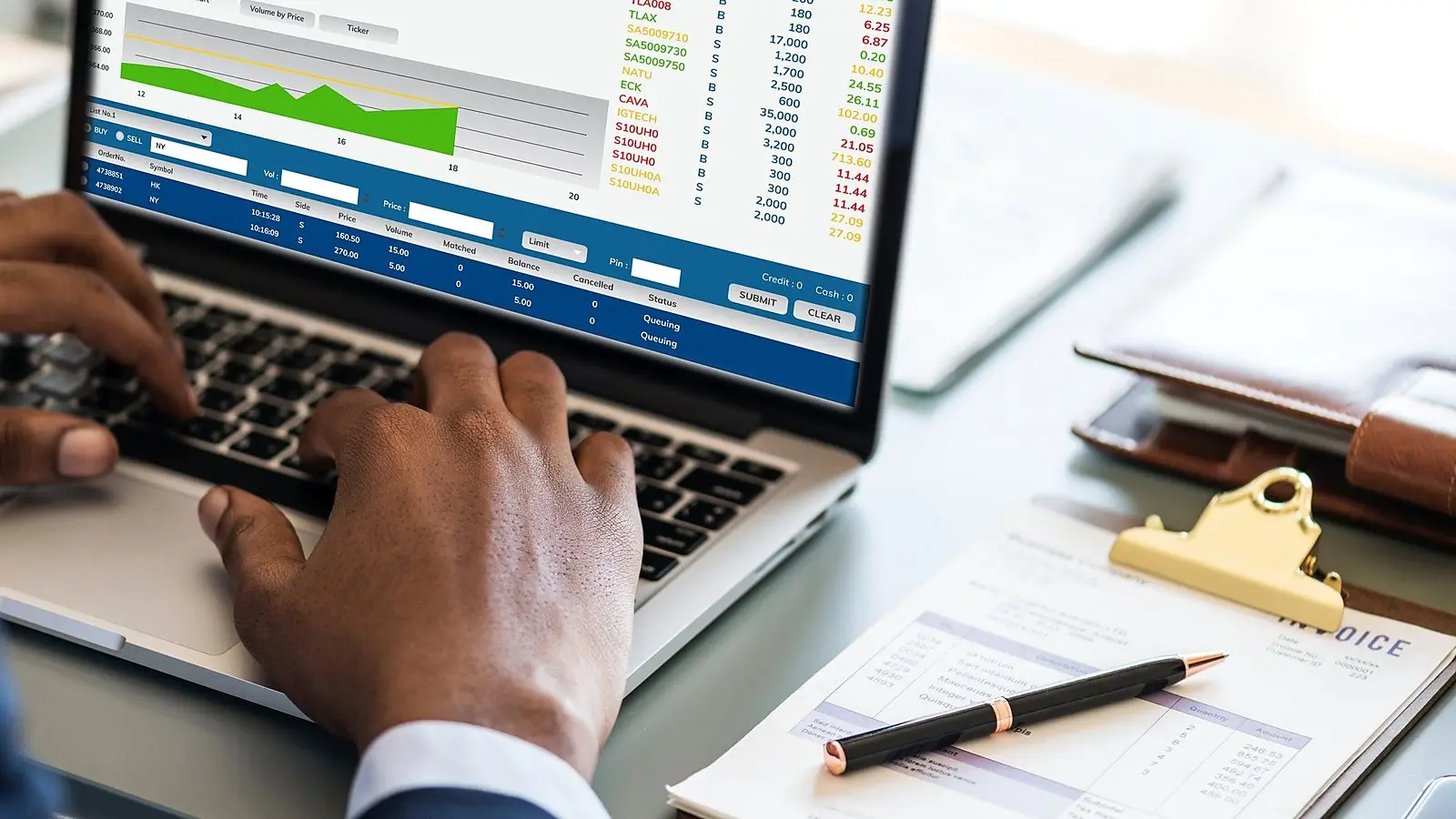 Reviewing finance reports on a laptop with a clipboard and pen