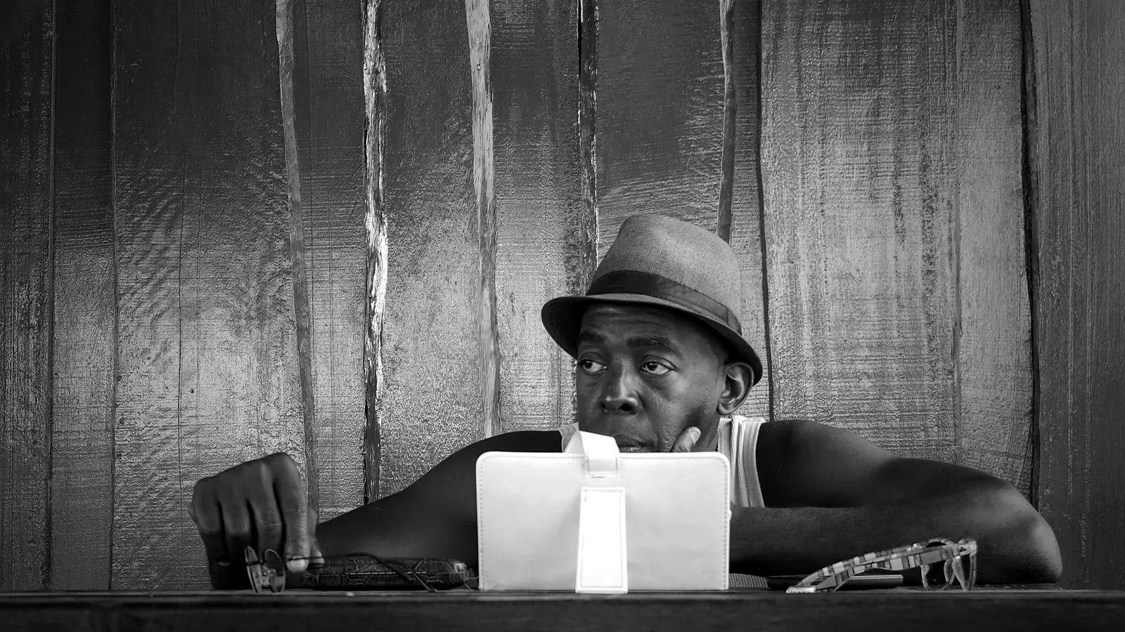 A man deep in thought at his desk at the end of a long day