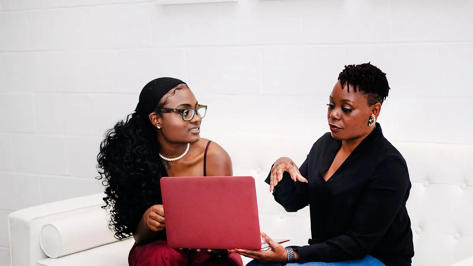 Two colleagues going through a review together on a laptop